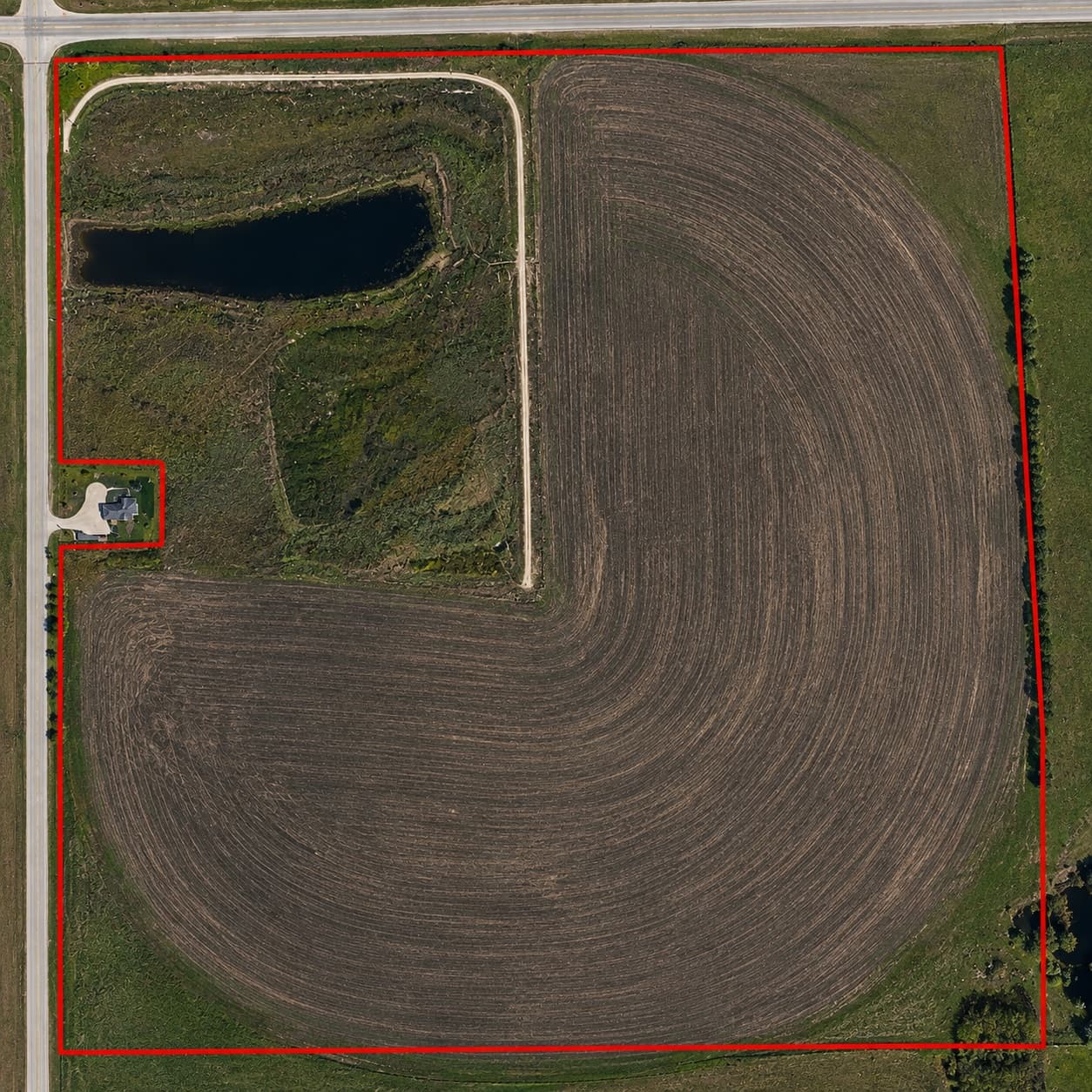 Aerial view of the Horner lands near Medicine Hat, a quarter section of irrigated field with a pond and farmstead at the northwest corner, outlined in red.